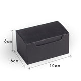 Black rectangular metal plate with engraved design on a white background