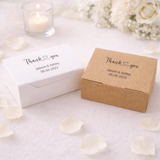 Two small personalized thank-you gift boxes on a white surface: one white box and one kraft brown box, both printed with the words 'Thank you' and the names 'Jabson & Ashley' with the date '08.08.