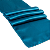 A teal blue satin table runner with a glossy sheen, folded to show its texture and color, set against a plain white background.
