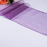 A purple organza table runner displayed alongside a partial view of a rose, indicating the runner's intended use for table decoration.
